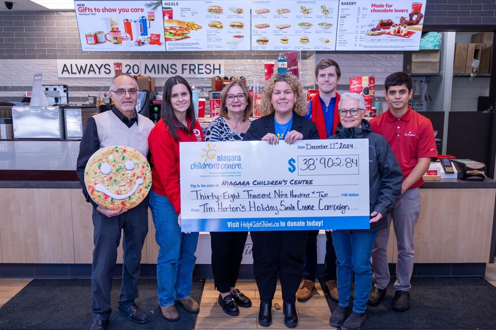 Group of people holding a cheque at Tim Hortons